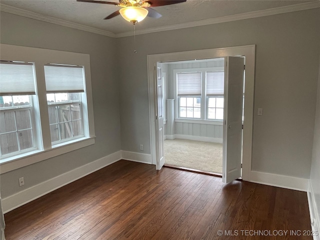 unfurnished room with ceiling fan, dark hardwood / wood-style floors, and crown molding