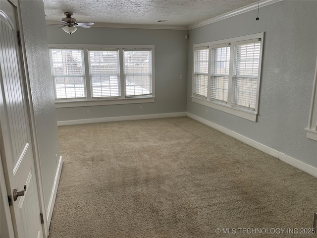 carpeted spare room with a textured ceiling, ceiling fan, and crown molding