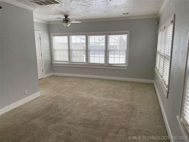 unfurnished room featuring light carpet, a wealth of natural light, and crown molding