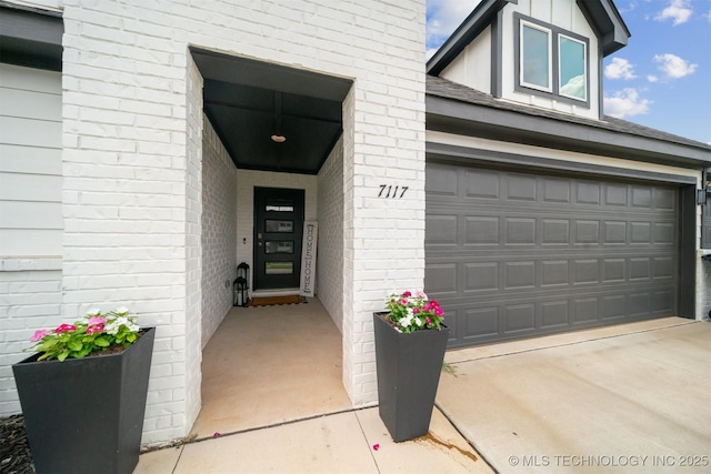 doorway to property with a garage