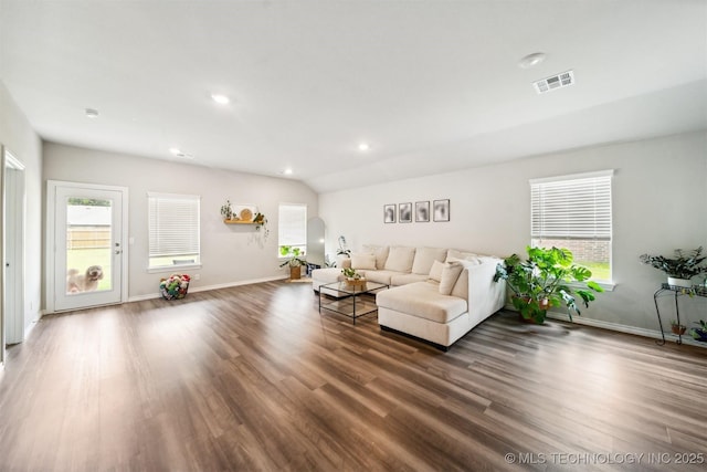 living room with dark hardwood / wood-style flooring and vaulted ceiling