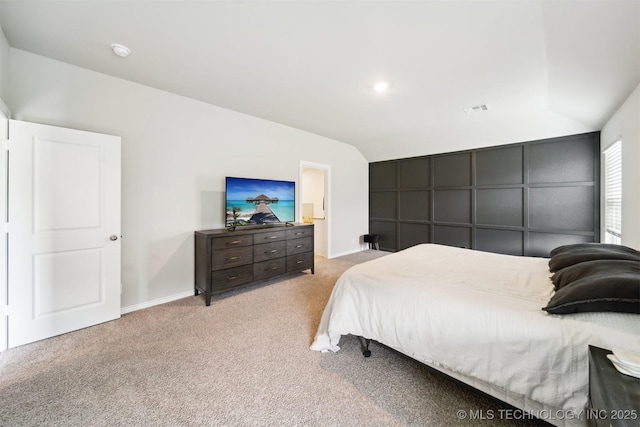 carpeted bedroom with lofted ceiling