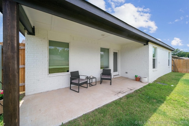 back of property with a yard and a patio