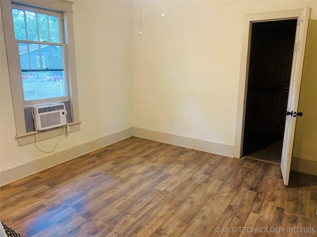 unfurnished room with hardwood / wood-style floors and cooling unit