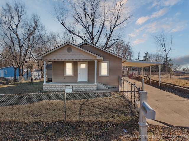 bungalow featuring a porch and a carport