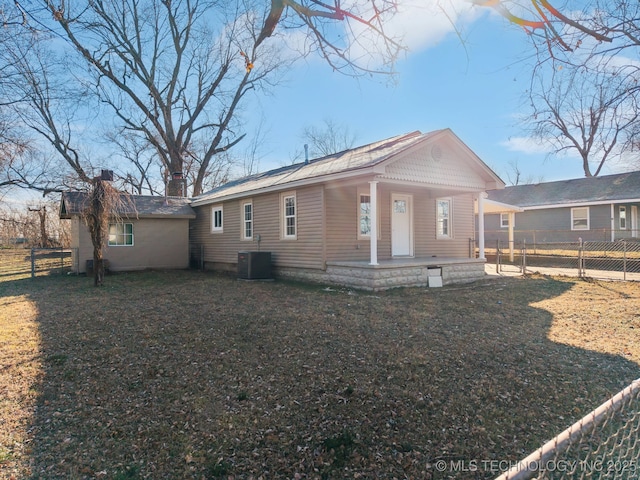 back of house with a lawn, cooling unit, and covered porch