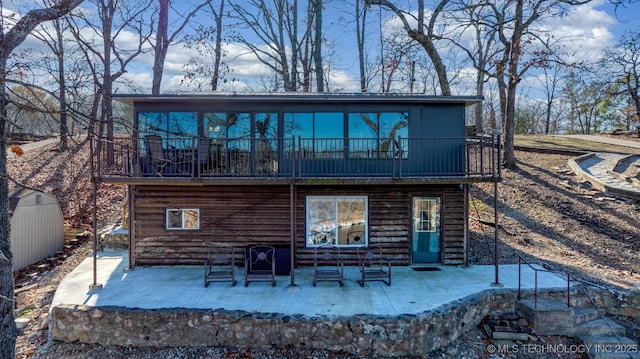 back of property featuring a patio area and a balcony