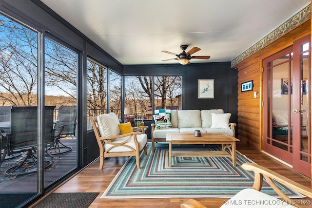 sunroom / solarium featuring ceiling fan