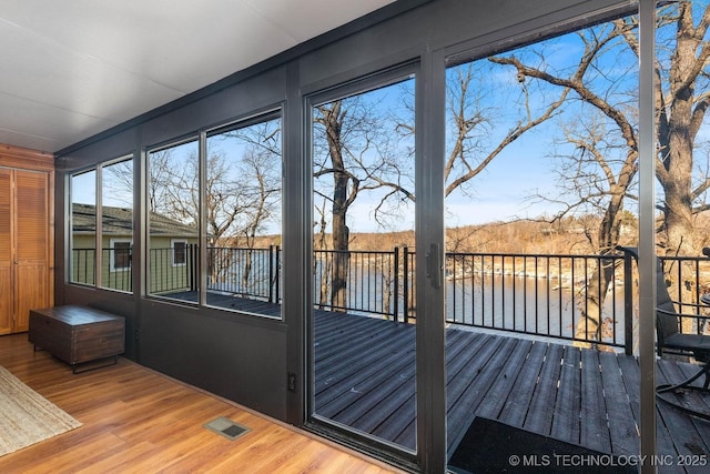 unfurnished sunroom with a water view