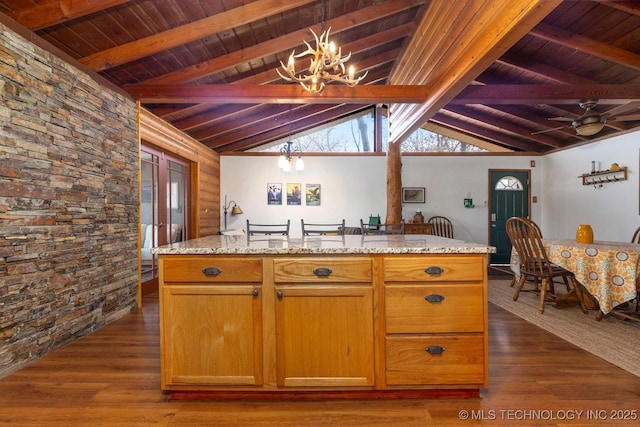 kitchen with lofted ceiling with beams, dark hardwood / wood-style flooring, wooden ceiling, and log walls