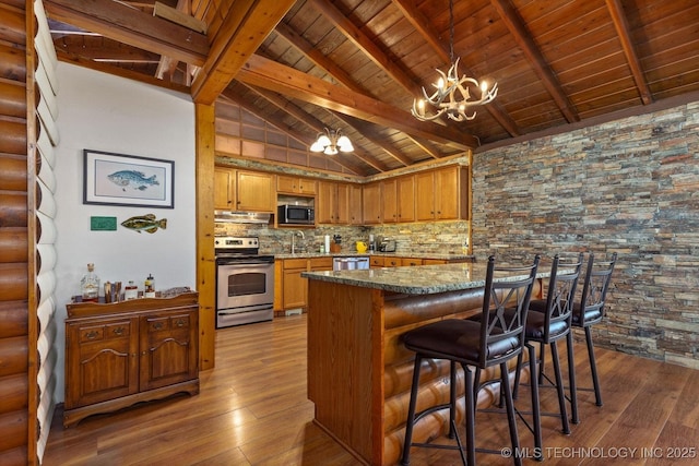 kitchen featuring stone countertops, beamed ceiling, a notable chandelier, dark hardwood / wood-style flooring, and stainless steel appliances