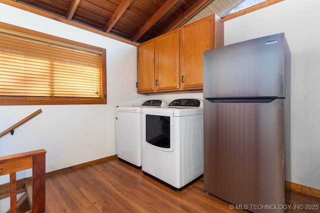 clothes washing area featuring cabinets, independent washer and dryer, dark hardwood / wood-style flooring, and wooden ceiling