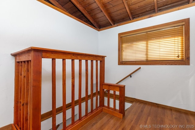 stairs featuring hardwood / wood-style floors, vaulted ceiling with beams, and wood ceiling