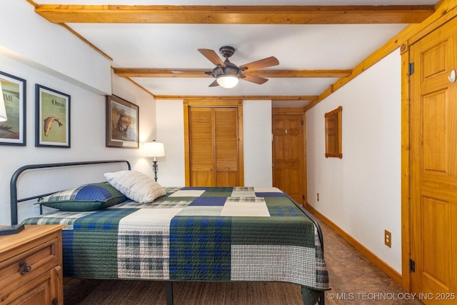 bedroom featuring carpet flooring, ceiling fan, beamed ceiling, and a closet