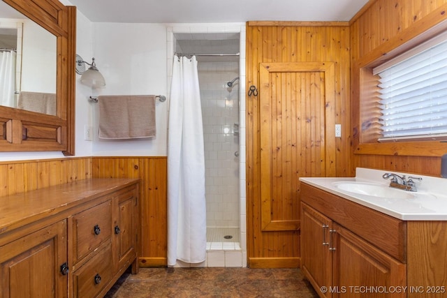 bathroom featuring wooden walls, vanity, and a shower with shower curtain