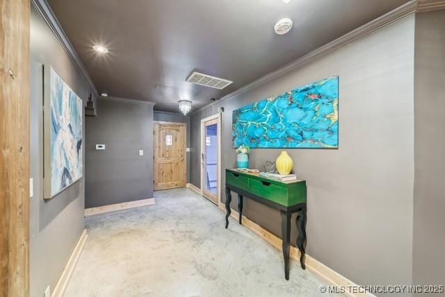 corridor with ornamental molding and concrete flooring