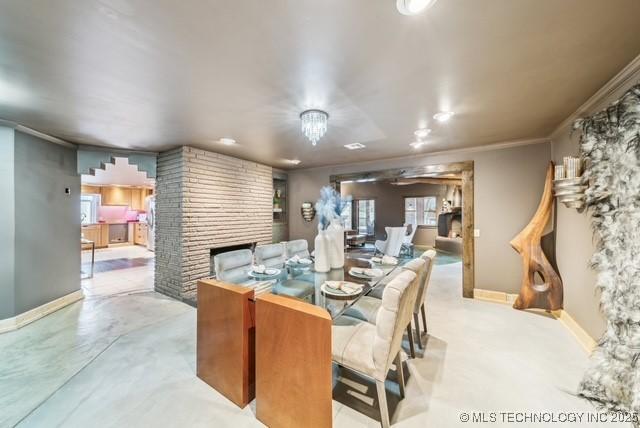 dining area featuring ornamental molding and a fireplace