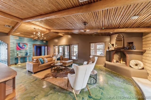 living room featuring wood ceiling, a fireplace, beamed ceiling, and a chandelier