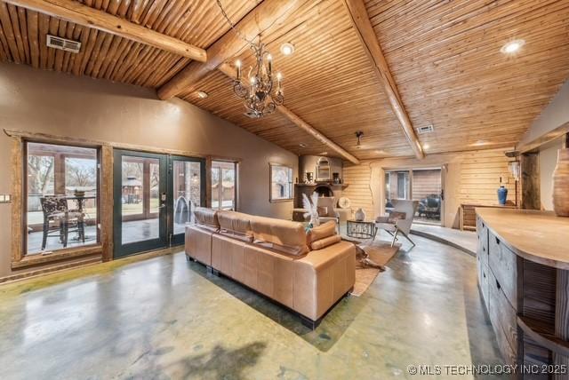 living room with a chandelier, concrete floors, lofted ceiling with beams, and wood ceiling