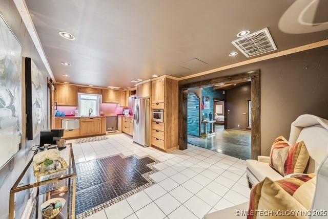 interior space featuring dishwasher, sink, stainless steel fridge, light tile patterned floors, and ornamental molding