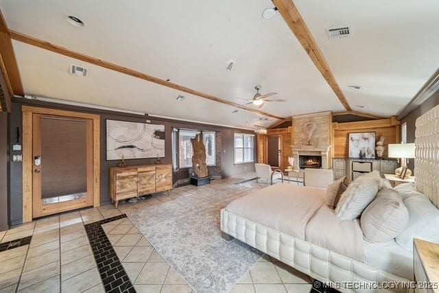 living room featuring vaulted ceiling with beams, ceiling fan, light tile patterned floors, and a premium fireplace