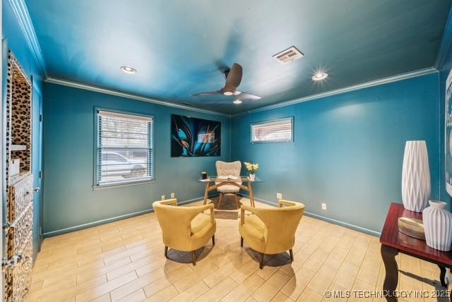 sitting room featuring ceiling fan, crown molding, and light hardwood / wood-style flooring