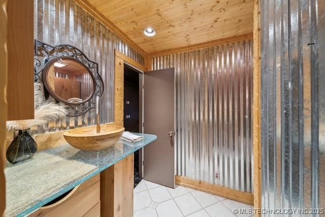 bathroom with tile patterned flooring, vanity, and wooden ceiling