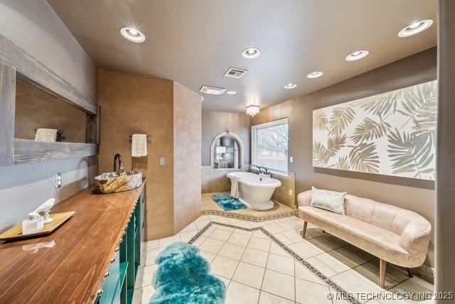 bathroom featuring tile patterned flooring and a washtub