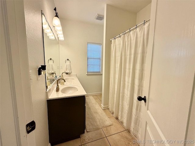 bathroom featuring tile patterned flooring and vanity