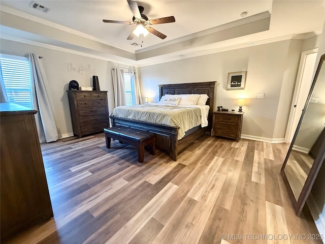 bedroom featuring ceiling fan, light hardwood / wood-style flooring, and multiple windows