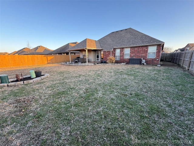 view of yard featuring a patio area and a fenced backyard