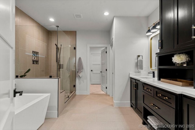 full bath featuring a freestanding tub, vanity, visible vents, recessed lighting, and a stall shower