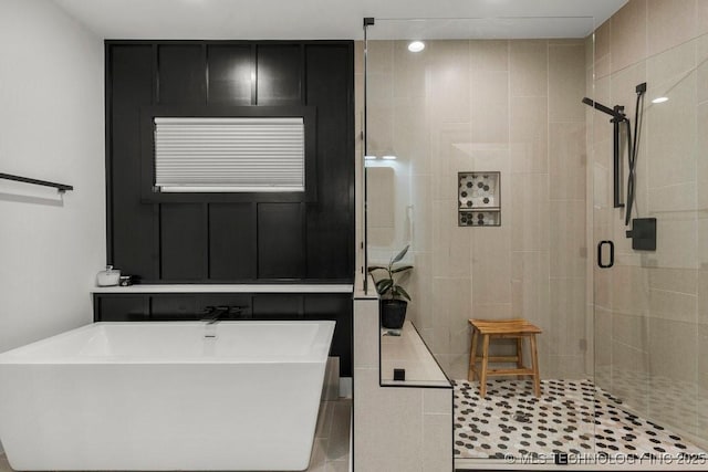 bathroom featuring tile patterned floors and separate shower and tub