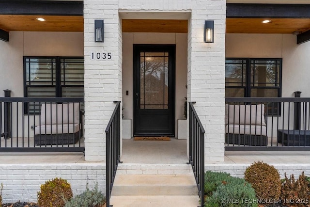 doorway to property featuring stucco siding