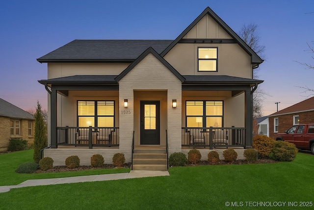 view of front of home with a front yard and a porch