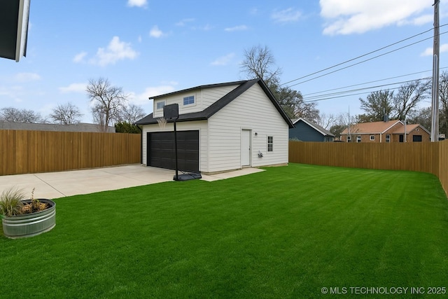 view of yard featuring fence and a garage
