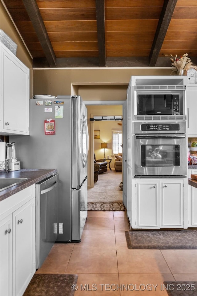 kitchen with white cabinetry, light tile patterned flooring, wood ceiling, and stainless steel appliances