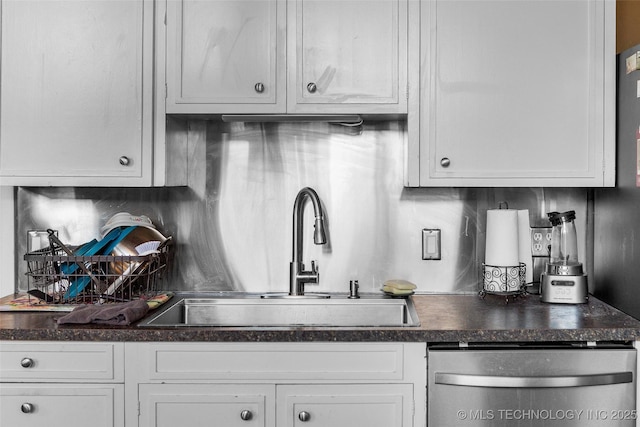 kitchen featuring white cabinets, backsplash, dishwasher, and sink