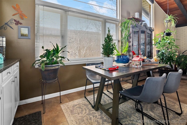 tiled dining area featuring wooden ceiling