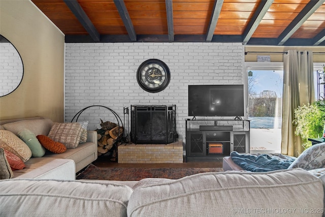 living room featuring a fireplace, beam ceiling, and wood ceiling