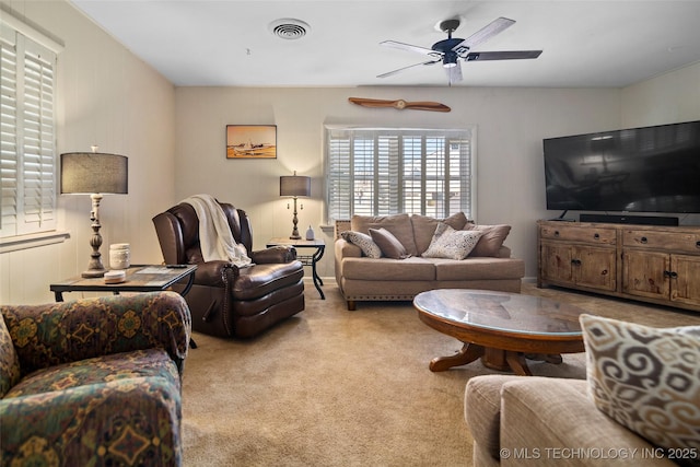 carpeted living room featuring ceiling fan