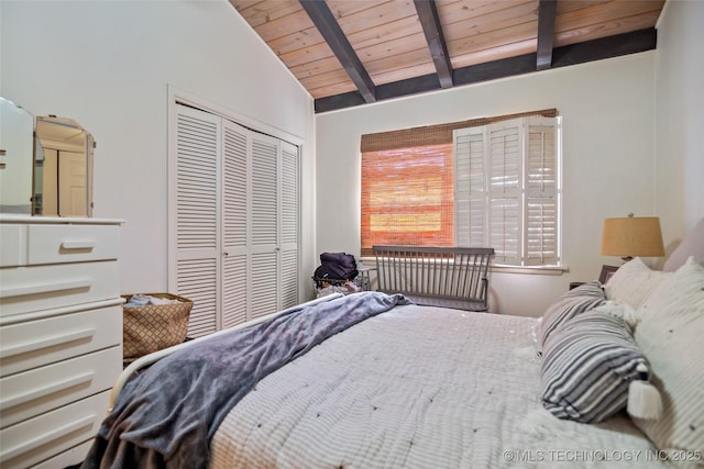 bedroom with multiple windows, lofted ceiling with beams, a closet, and wooden ceiling