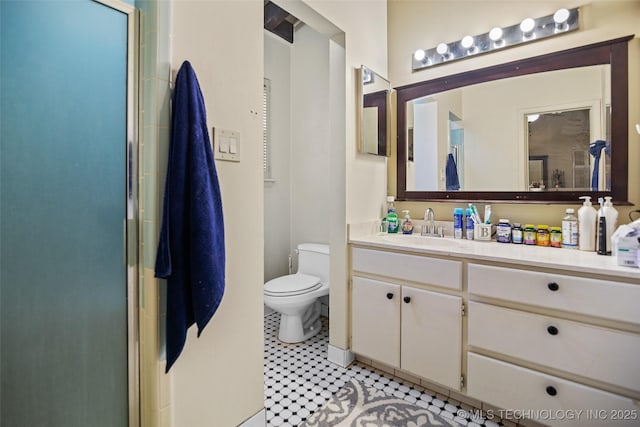 bathroom with tile patterned flooring, a shower with door, vanity, and toilet