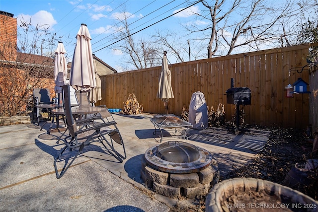 view of patio / terrace featuring an outdoor fire pit