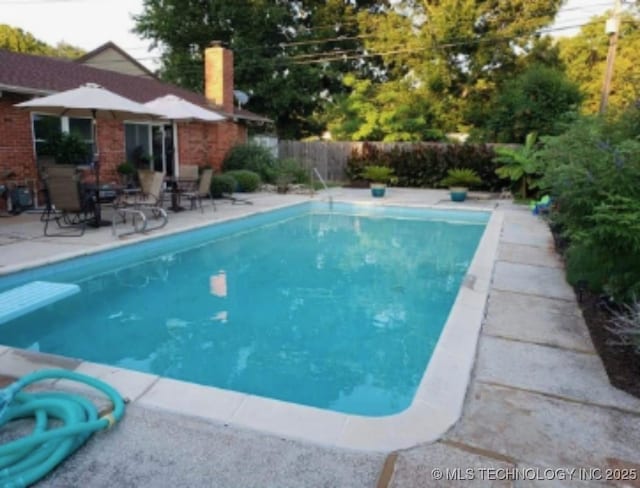 view of swimming pool featuring a patio area