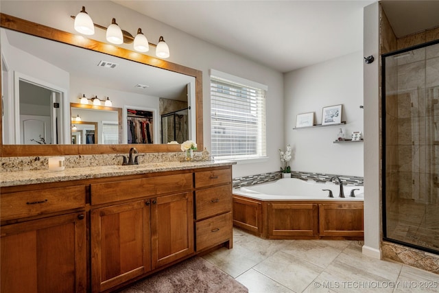 bathroom with tile patterned floors, vanity, and separate shower and tub