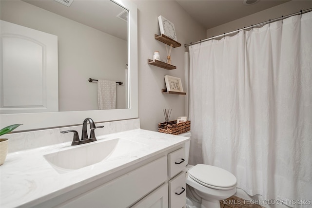 bathroom featuring vanity and toilet