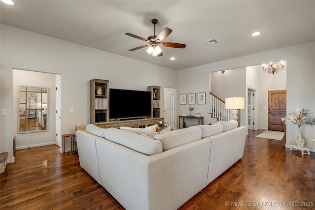 living room featuring dark hardwood / wood-style floors and ceiling fan with notable chandelier