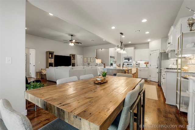 dining area with ceiling fan and dark hardwood / wood-style flooring