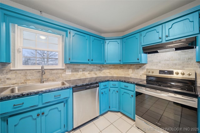 kitchen with light tile patterned floors, stainless steel appliances, blue cabinets, and sink